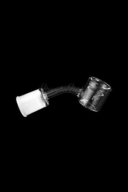 Clear glass dab rig attachment floating against a black background.
