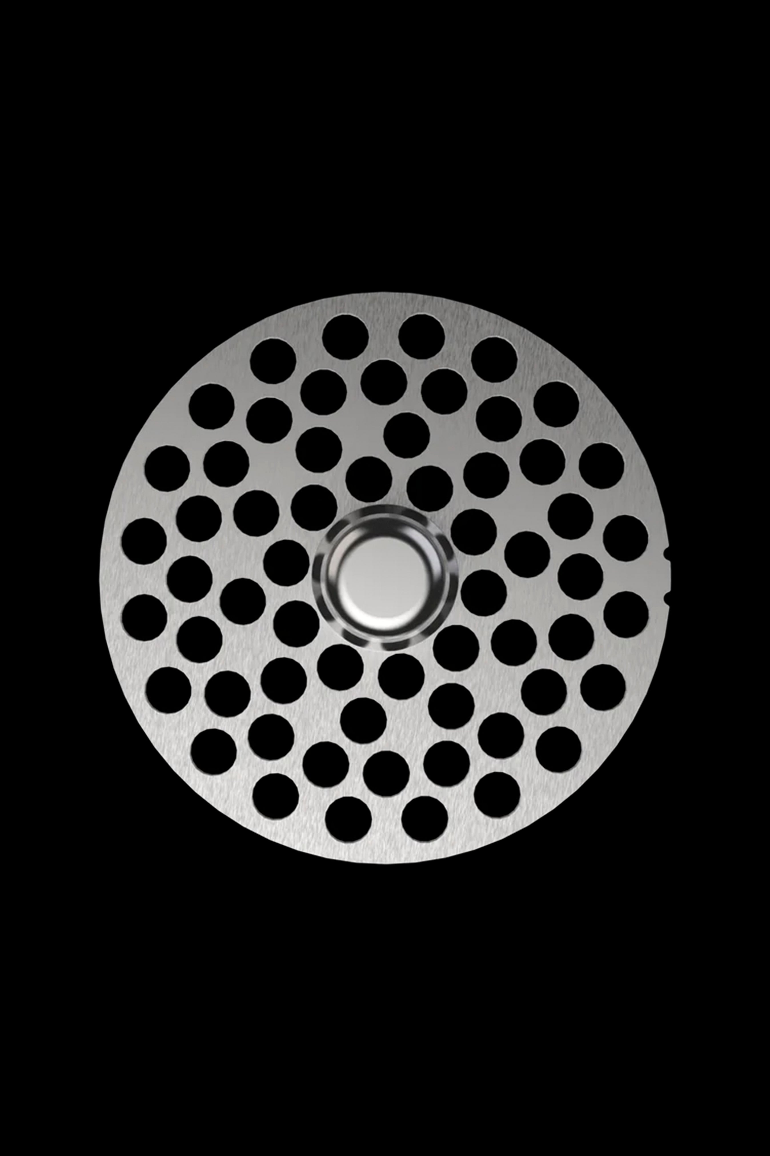 Metal grinder plate with numerous circular holes, isolated on black.