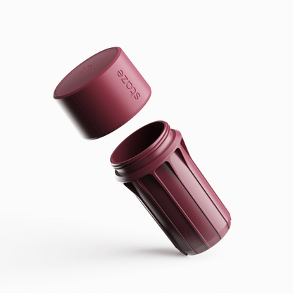 Angled close-up of the brick-colored STAZE PRESERVE showing its threaded opening and embossed lid hovering above the cylindrical body.