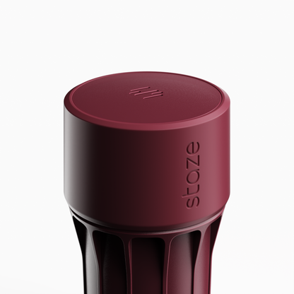 Close-up top-down view of the maroon STAZE PRESERVE showing its circular lid, subtle logo grooves, and ribbed cylindrical body.