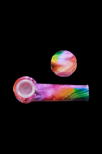 Colorful silicone cannabis pipe and cap against a black background.
