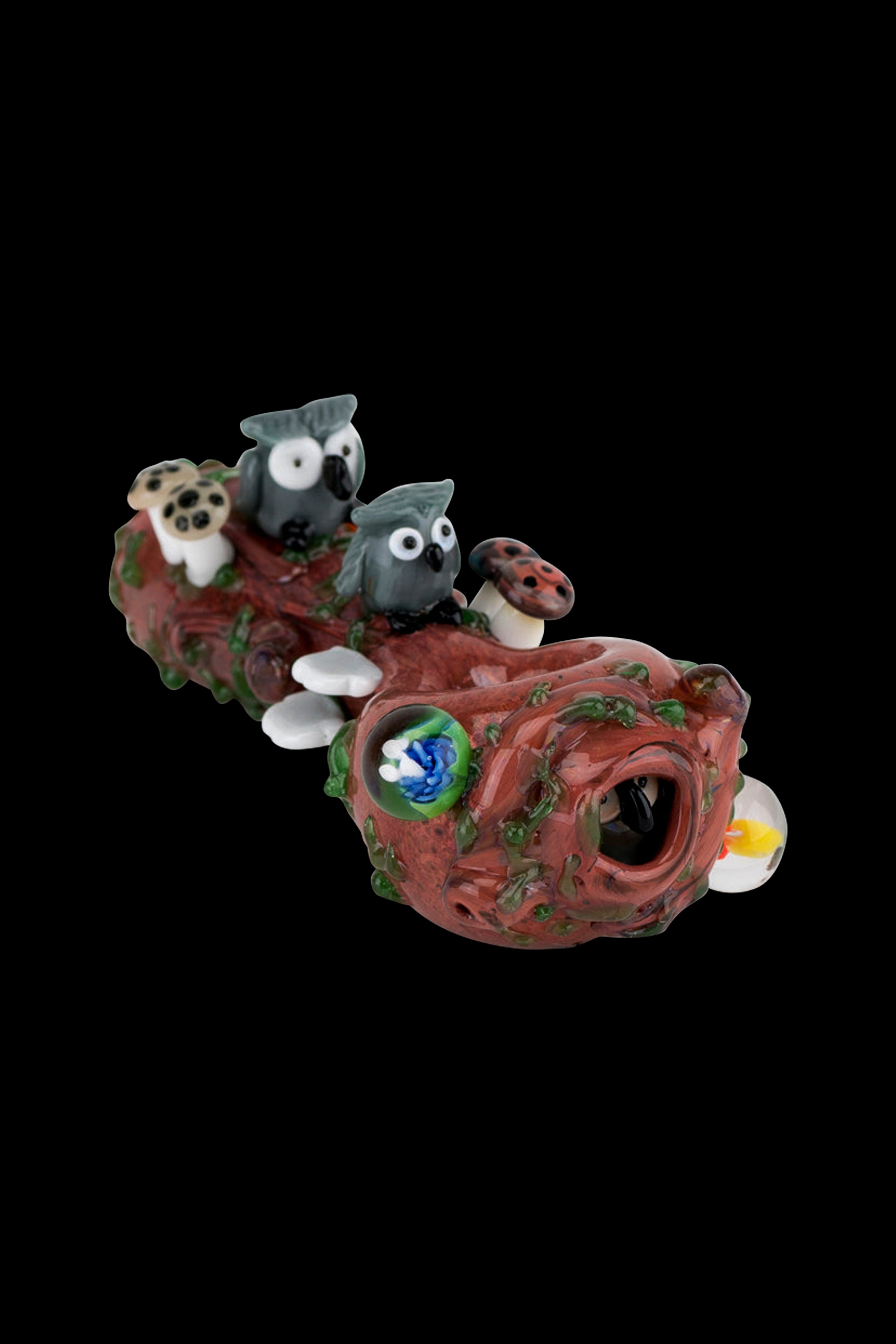 Hand-blown glass pipe shaped like a forest scene with whimsical owl and mushroom details.