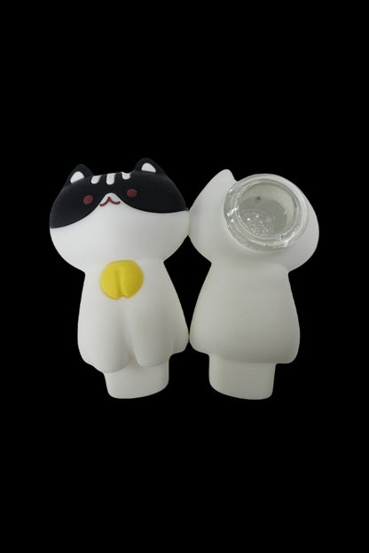 White ceramic pipe shaped like a cat with black ears and a yellow button.