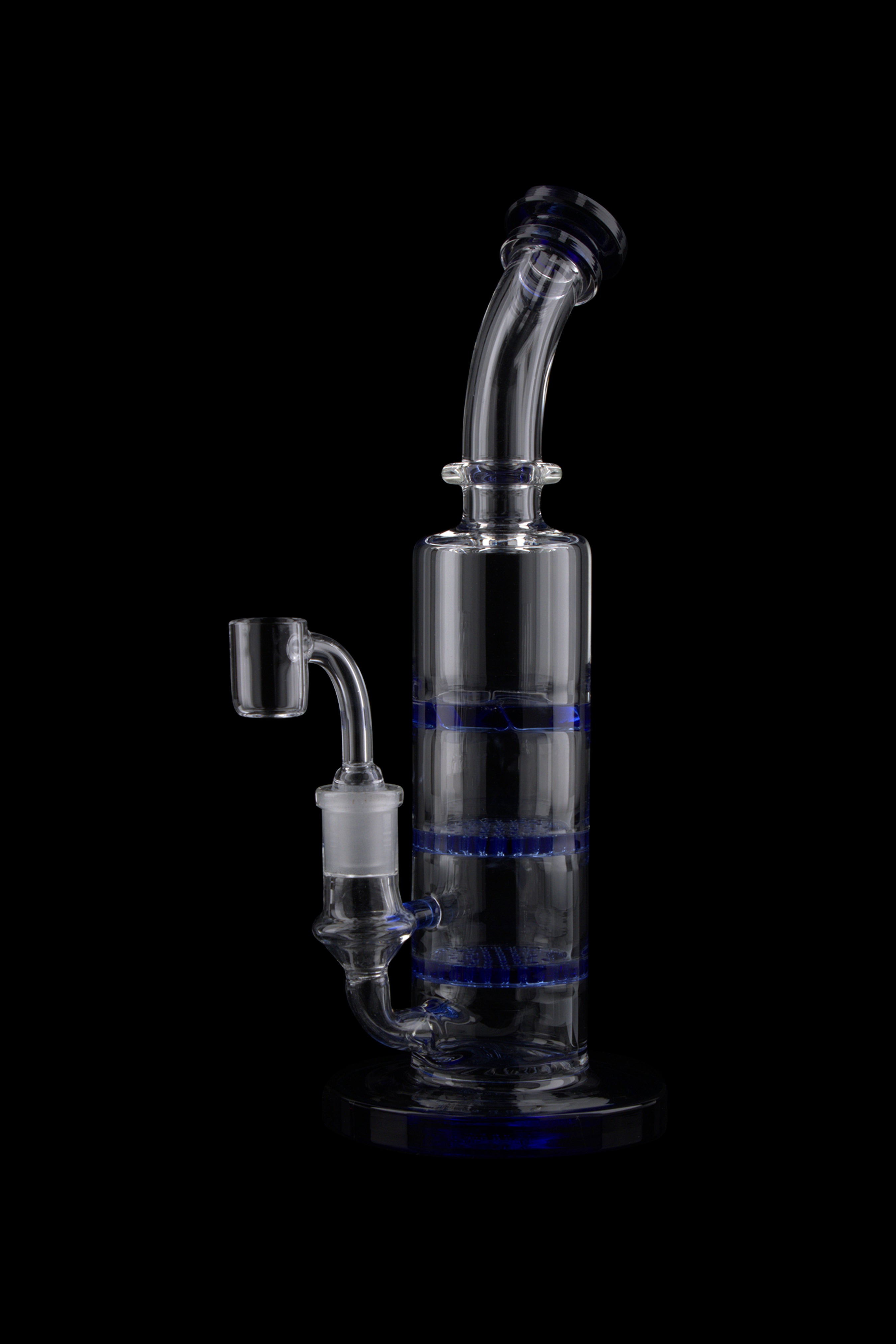 Studio-lit, side view of the Triple Honeycomb Dab Rig showing its clear glass neck, blue honeycomb percs, and angled mouthpiece against a black background