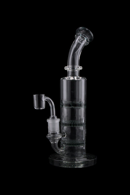 Angled close-up of the Triple Honeycomb Dab Rig showing its clear glass neck, percolator chamber, and joint against a black background.