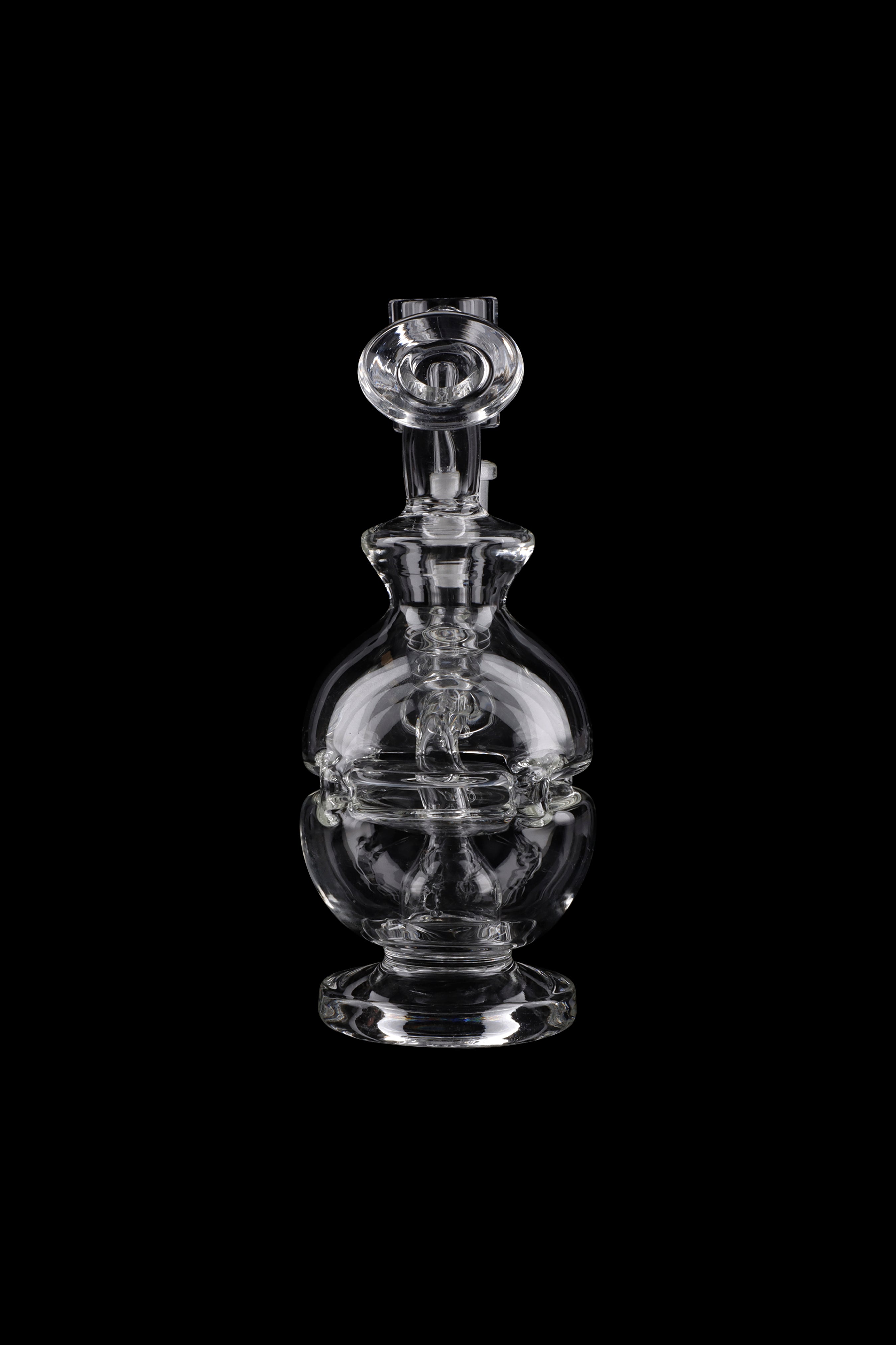 Clear glass dab rig with intricate bulbous design, isolated on black.