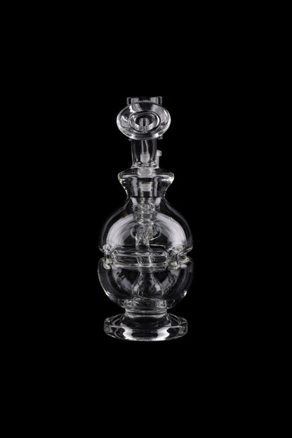 Clear glass dab rig with intricate bulbous design, isolated on black.