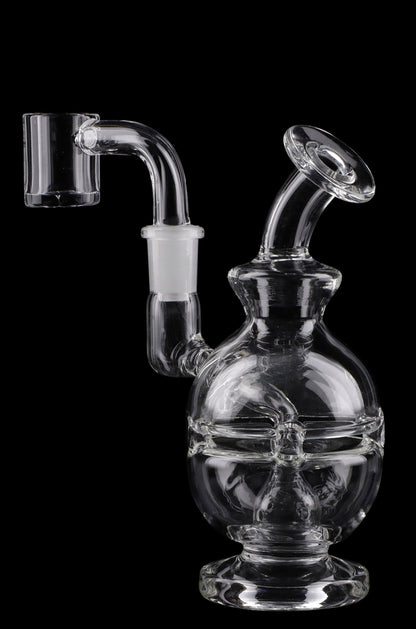 Clear glass water pipe (rig) with intricate design and accompanying glass piece, isolated on black.