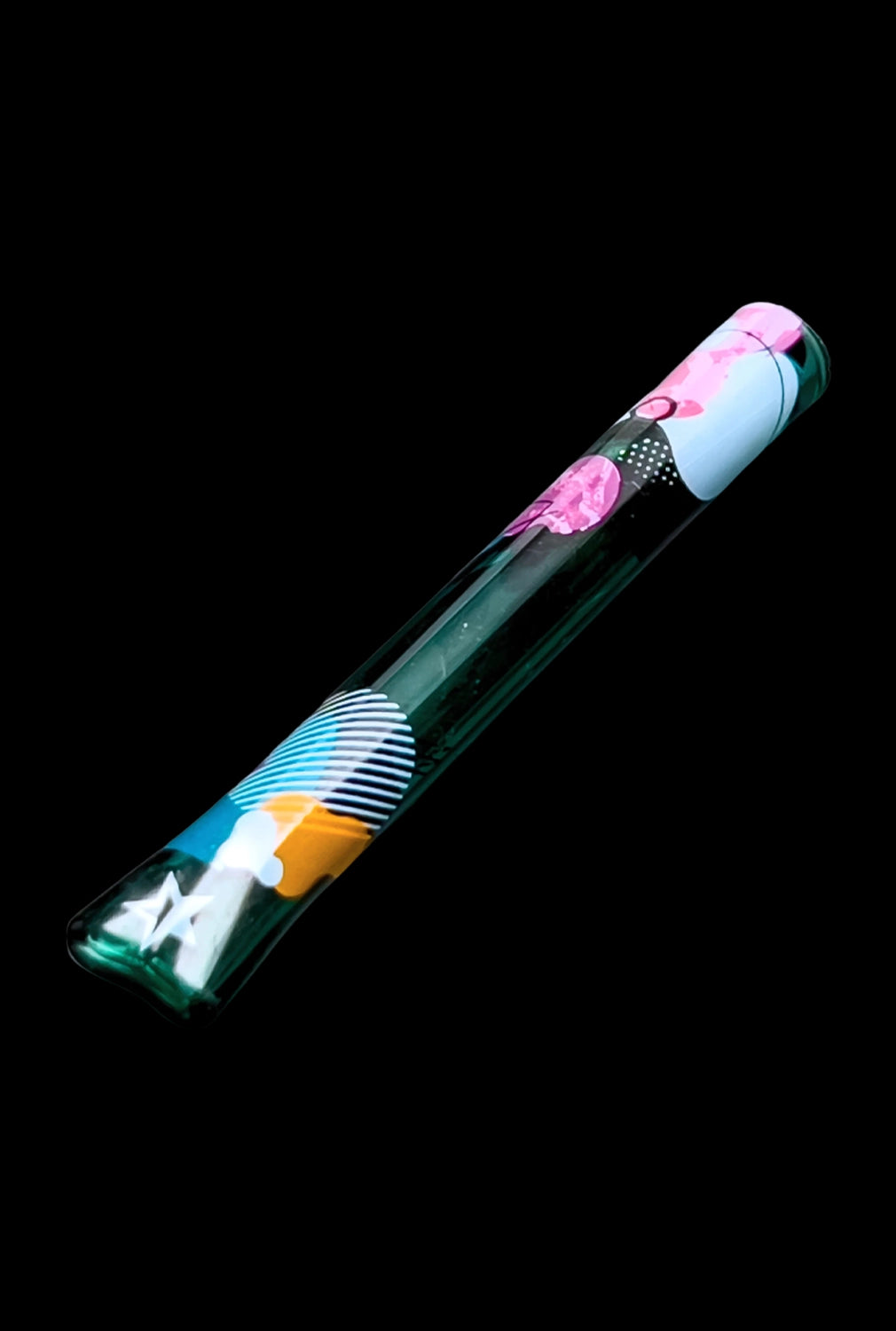Clear acrylic tube containing a rolled cannabis joint with colorful patterned paper, against a black background.