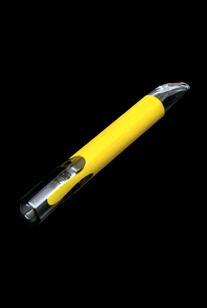 Yellow glass cannabis smoking pipe with visible contents.