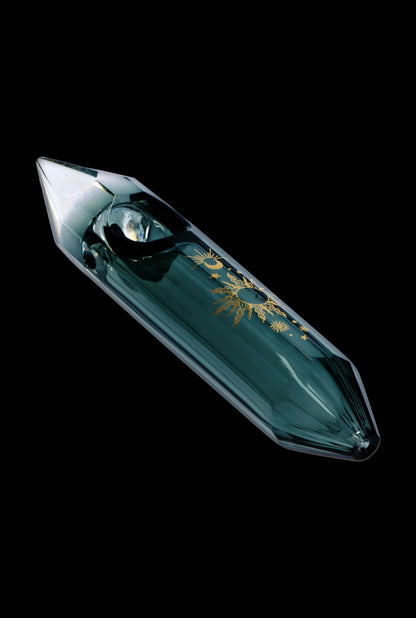 Emerald green glass pipe with gold celestial designs, isolated on black.