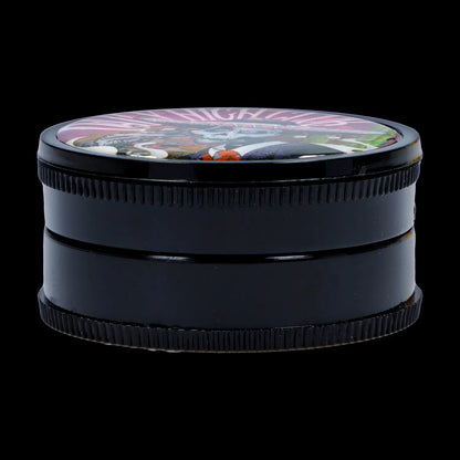 Low-angle close-up of a glossy black Black Skull Mini Travel Grinder showing its textured side ridges and a colorful domed skull design on the lid.