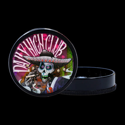 Close-up front view of the Black Skull Mini Travel Grinder showing a colorful skull wearing a sombrero graphic on the lid.