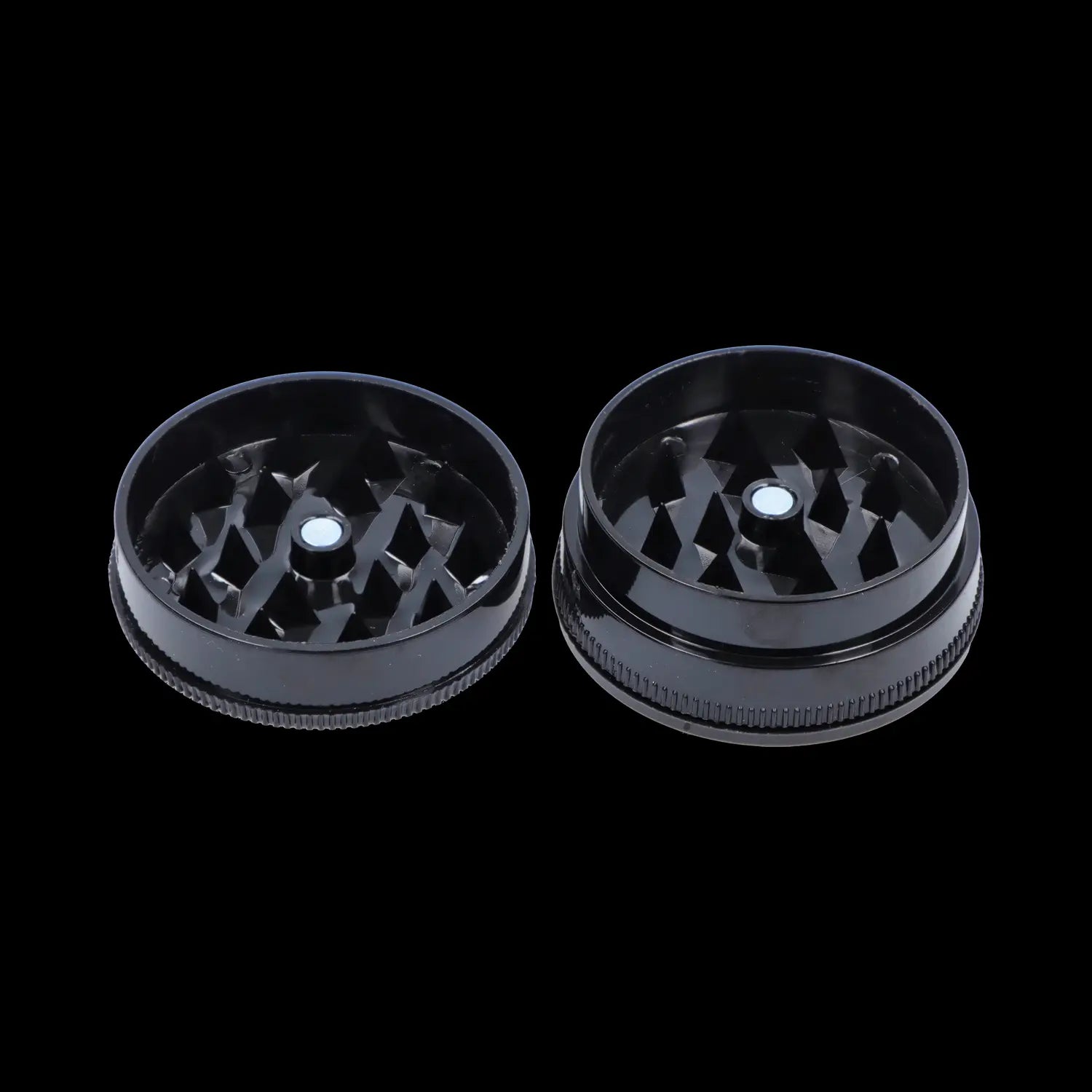 Top-down view of the open Black Skull Mini Travel Grinder showing both black interlocking halves with diamond-shaped teeth.