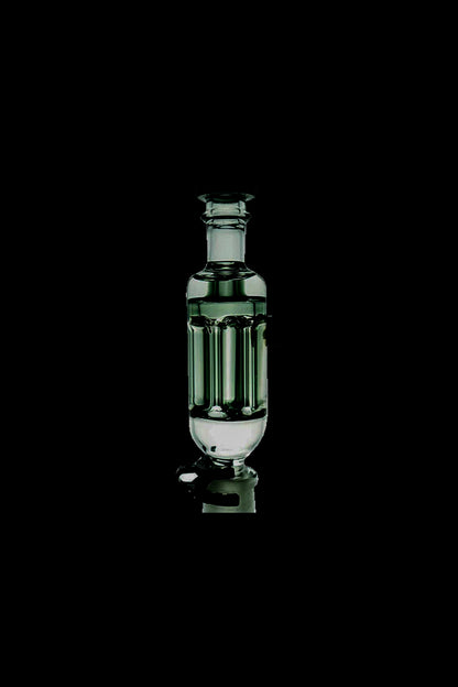 Green glass bubbler for cannabis smoking, isolated on a black background.