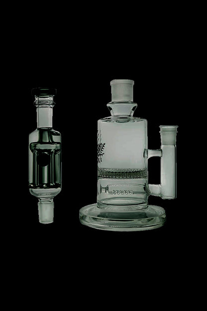 Glass bubbler and water pipe with intricate designs, isolated on a black background.