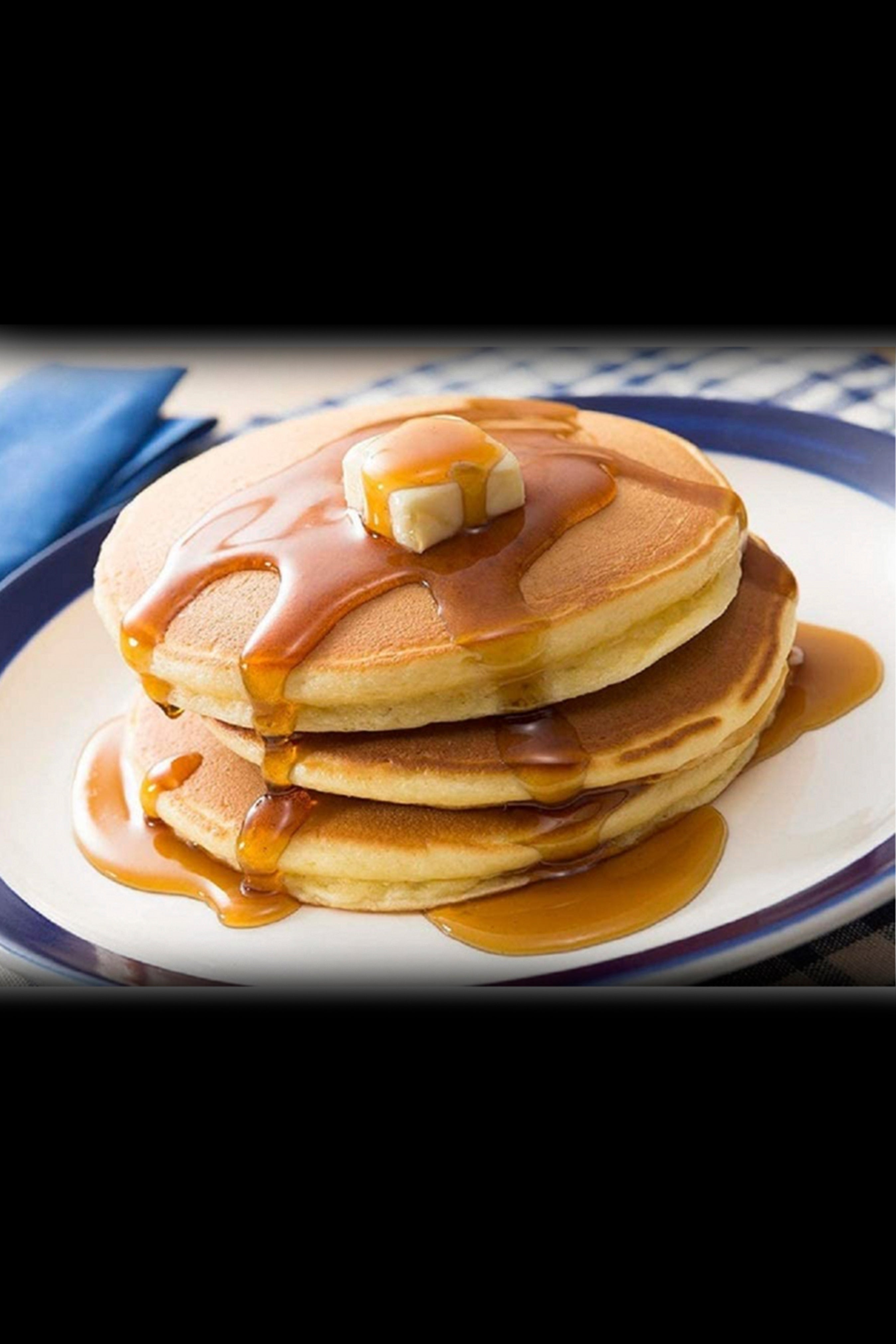Stacked pancakes drizzled with syrup and topped with butter, potentially referencing “high” breakfast vibes or cannabis-infused edibles.
