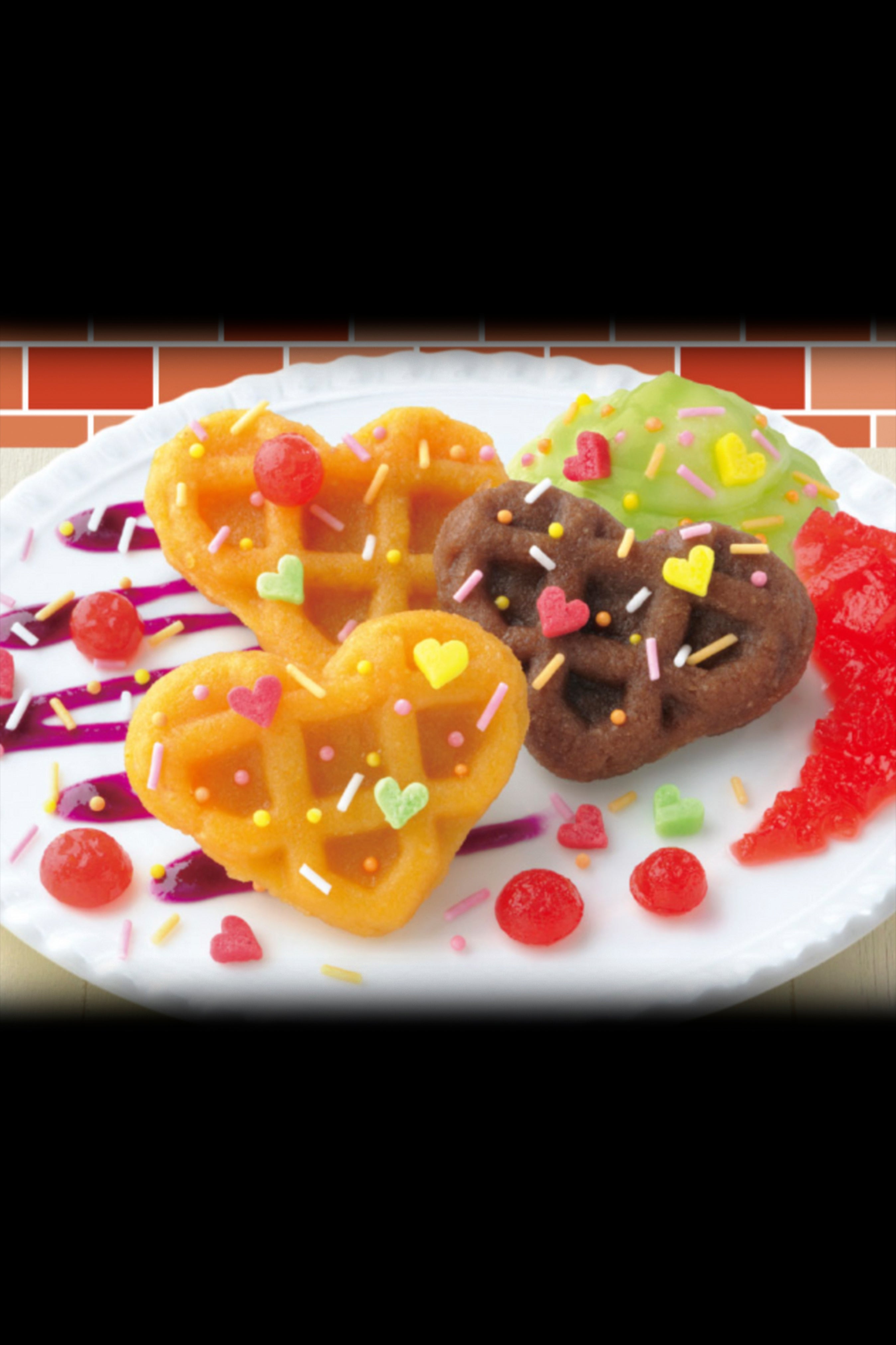 Heart-shaped cannabis edibles decorated with colorful sprinkles and candy hearts on a white plate.
