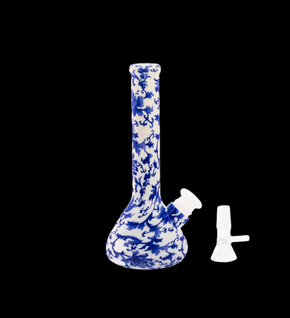 Blue and white patterned glass water pipe with a separate glass bowl piece, isolated on a black background.