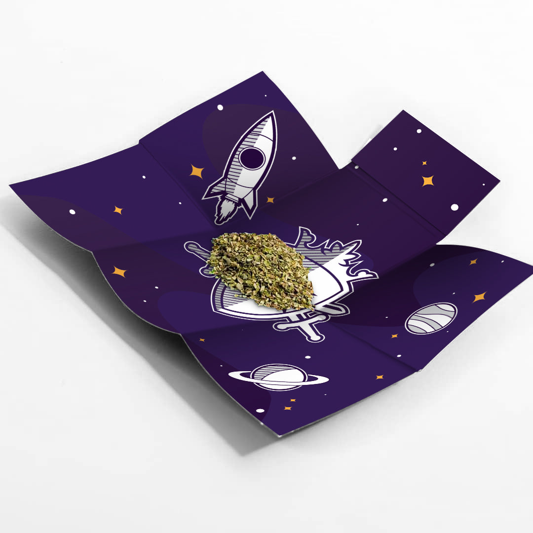Cannabis bud displayed on a dark purple tray with a space-themed design featuring rockets and planets.