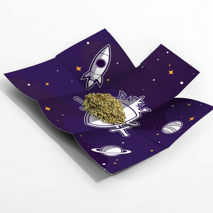 Cannabis bud displayed on a dark purple tray with a space-themed design featuring rockets and planets.