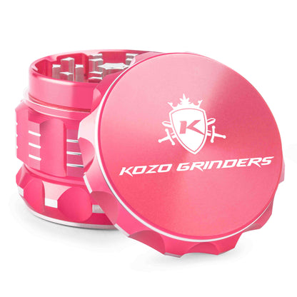 Pink metal cannabis grinder with the Kozo Grinders logo.