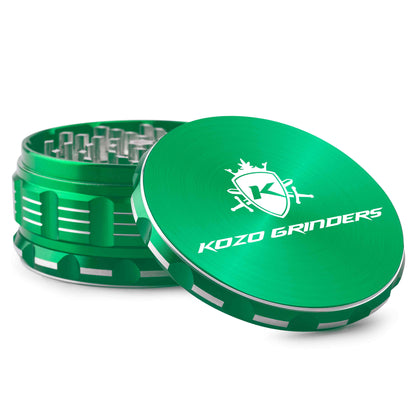 Green metal cannabis grinder with branding, open to reveal ground herb inside.