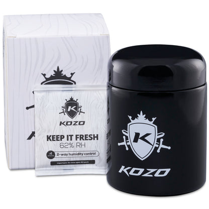 Black and white cannabis storage container with “KOZO” branding and “Keep it Fresh 62% RH” text, accompanied by humidity control packets.