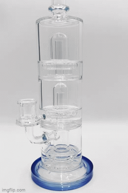 Clear glass water pipe with a UFO shape, triple percolation chambers, and a downstem visible within.