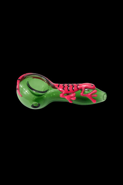 Green glass pipe with red skull and bone design.