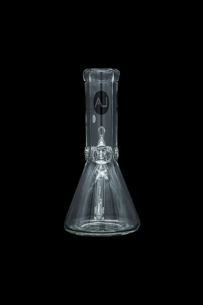 Clear glass beaker bong with intricate percolator, isolated on black.