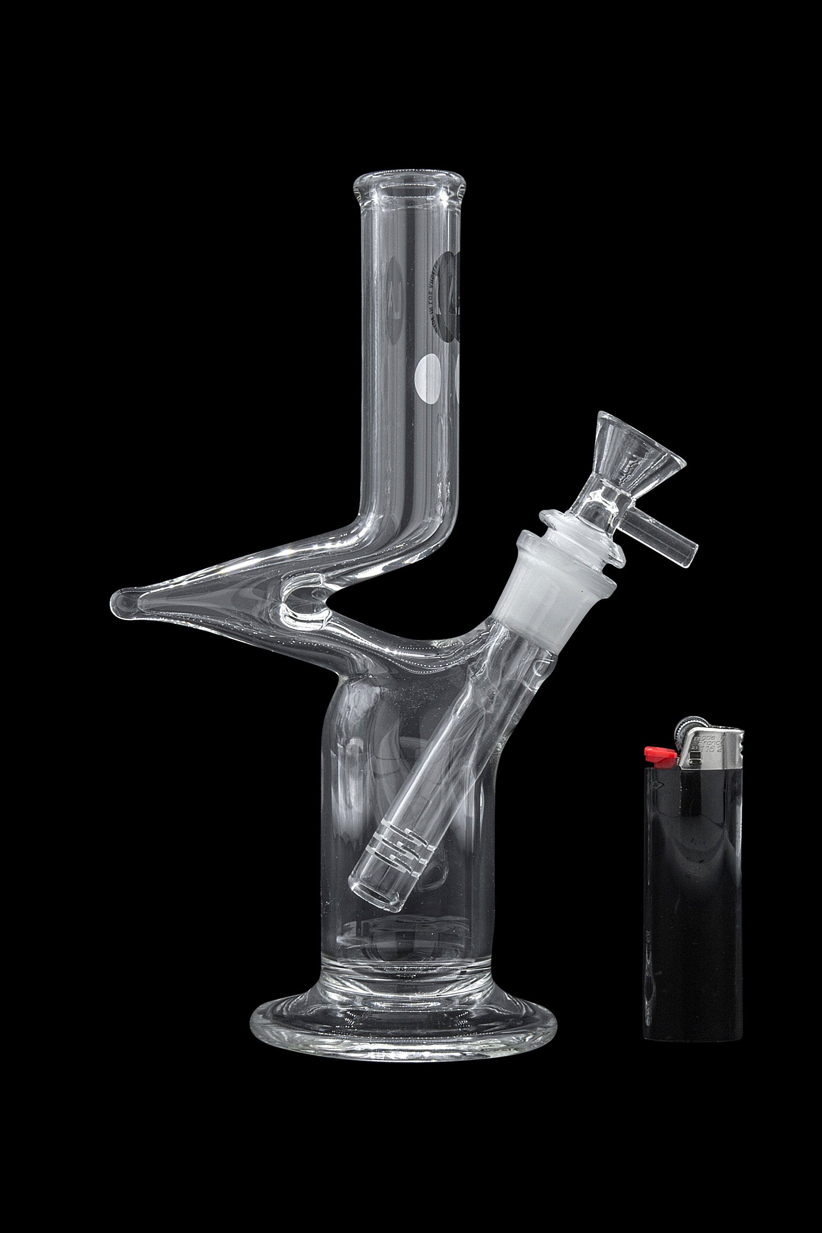 Clear glass bong with a lighter beside it, against a black background.