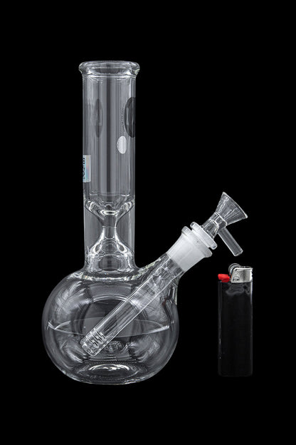 Glass water pipe (bong) and lighter on a black background.