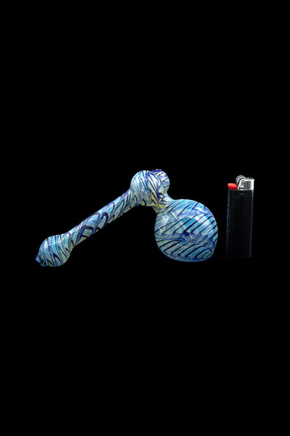 Blue glass bubbler pipe with a lighter beside it on a black background.