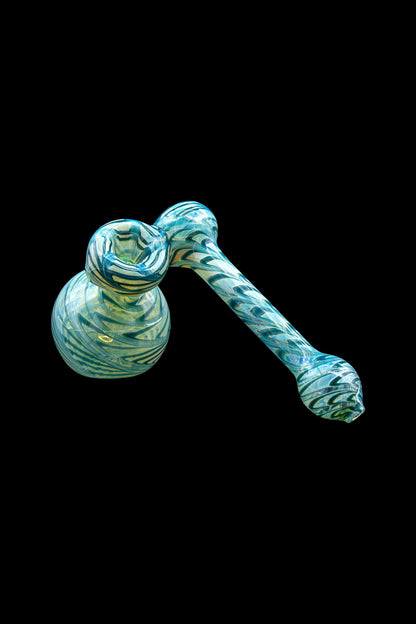Hand-blown glass bubbler with teal and white swirling patterns.