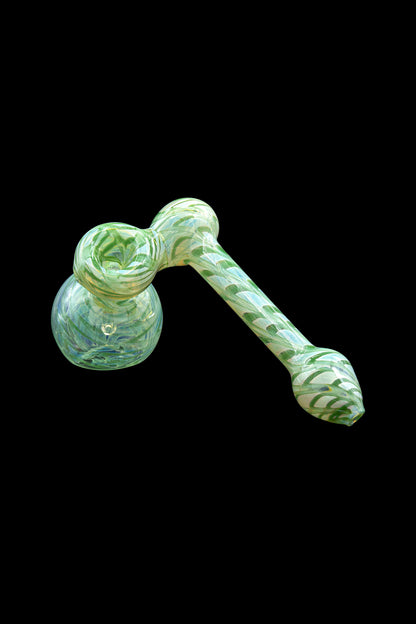 Green glass bubbler with leaf patterns, isolated on a black background.