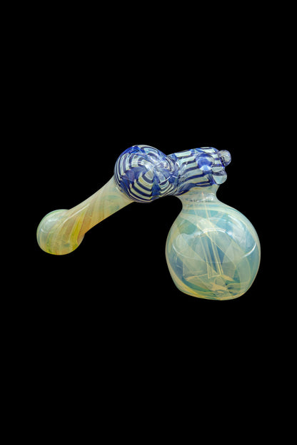 Hand-blown glass pipe with blue and green swirls against a black background.