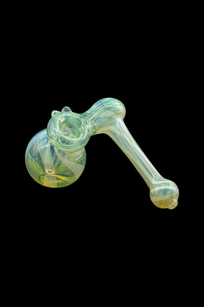 Green glass bubbler pipe for smoking cannabis, isolated on a black background.
