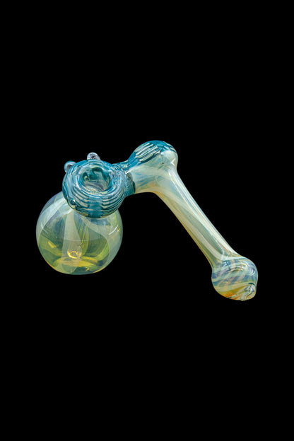 Glass bubbler pipe with blue and iridescent swirls, isolated on a black background.