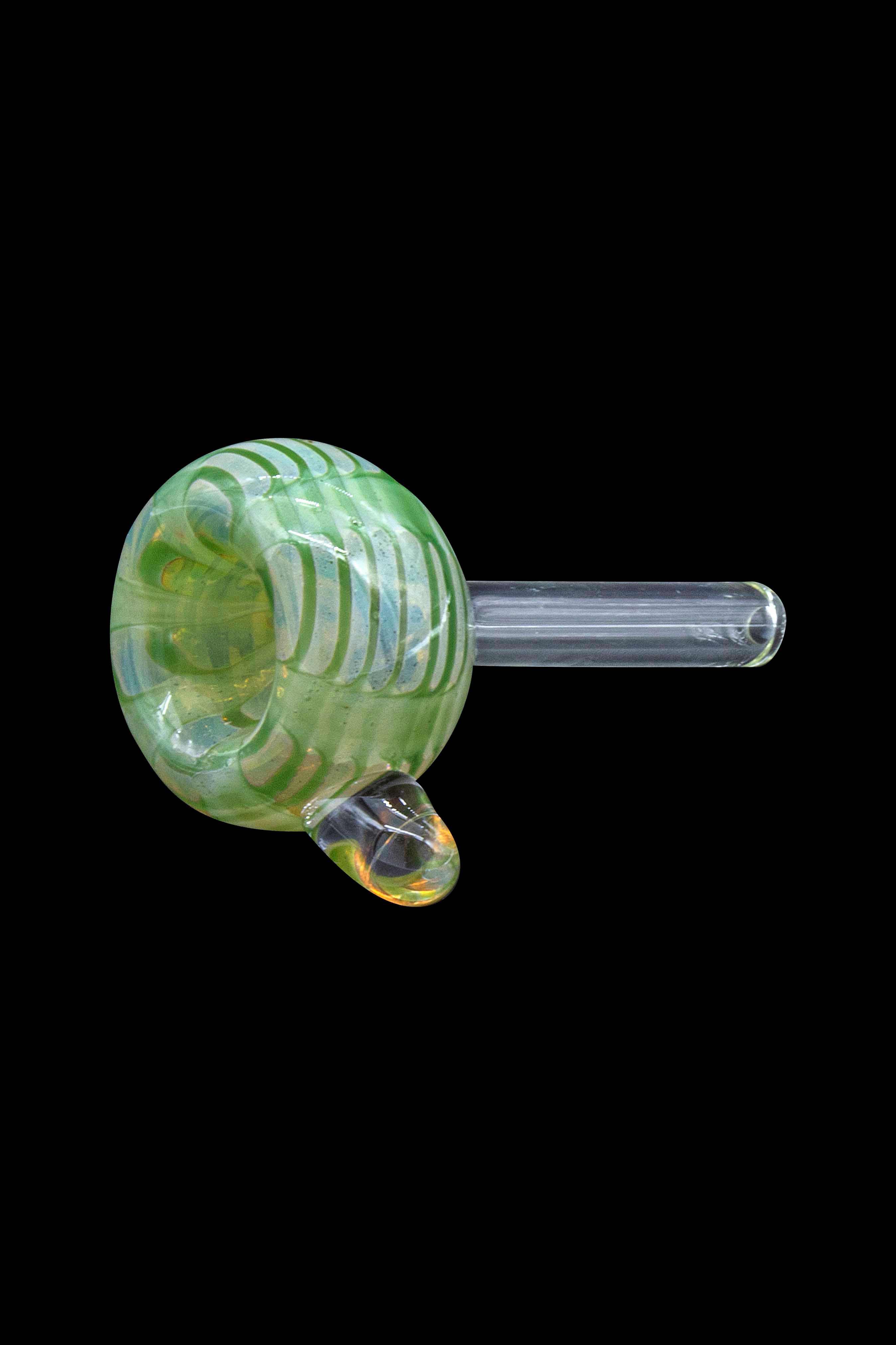Green glass cannabis pipe isolated on a black background.