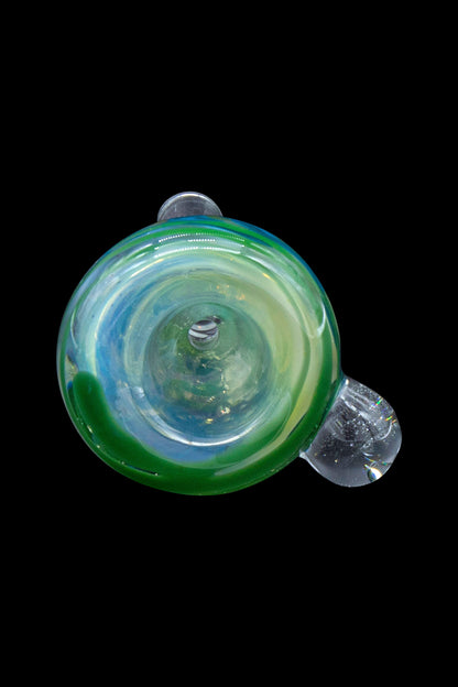 Green and blue glass cannabis pipe against a black background.