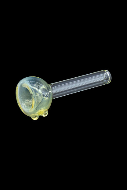 Green glass smoking pipe isolated on a black background.