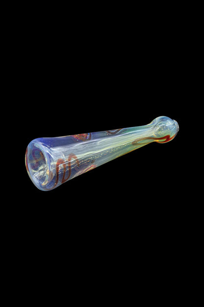 Hand-blown glass pipe with swirling blue, red, and gold patterns, isolated on a black background.