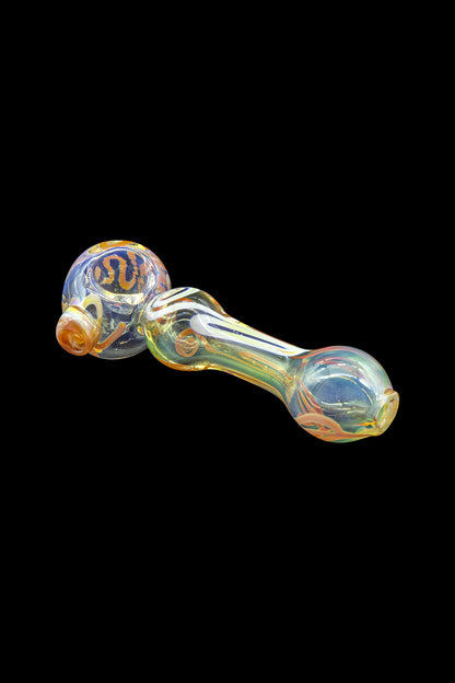 Iridescent glass pipe with orange and gold accents against a black background.