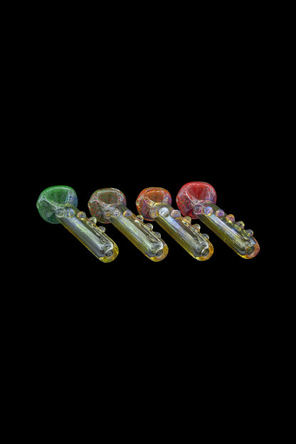 Assortment of colorful glass smoking pipes on a black background.