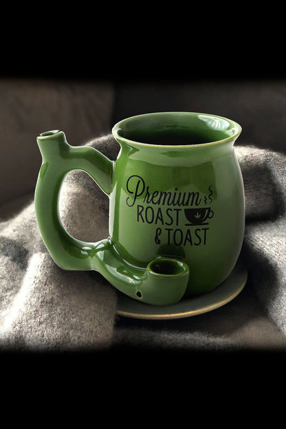 Green ceramic mug with built-in pipe and text “Premium Roast” on a textured surface.