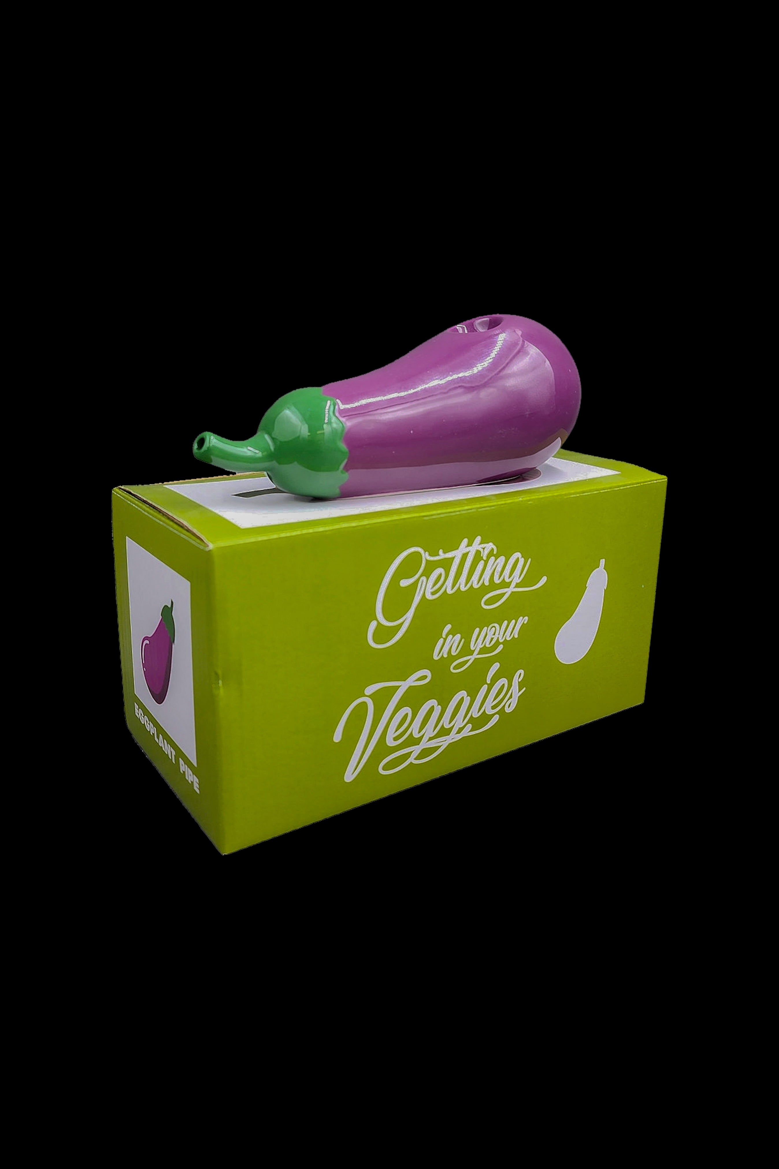 Eggplant-shaped cannabis pipe displayed in its packaging, reading "Getting in your Veggies."