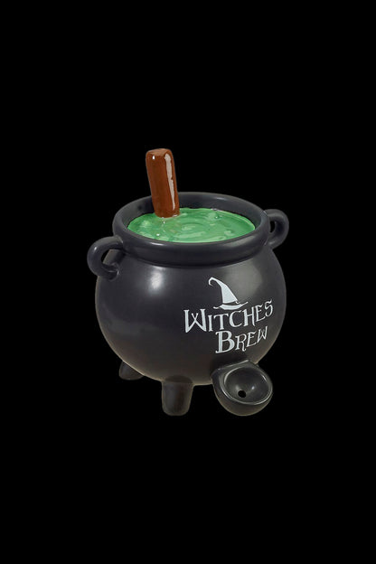 Black cauldron-shaped cannabis water pipe with green liquid inside, labeled “Witches Brew.”"