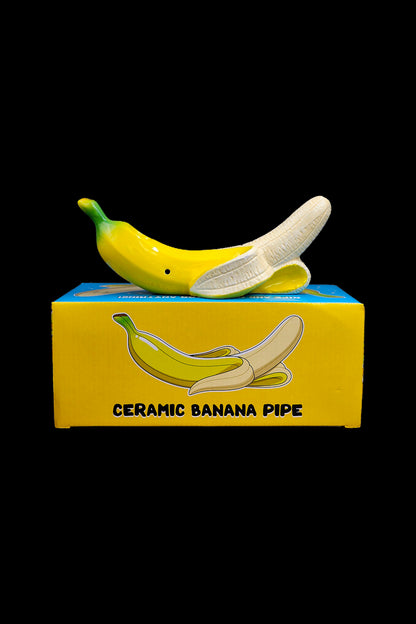 Yellow ceramic banana pipe displayed in its packaging.
