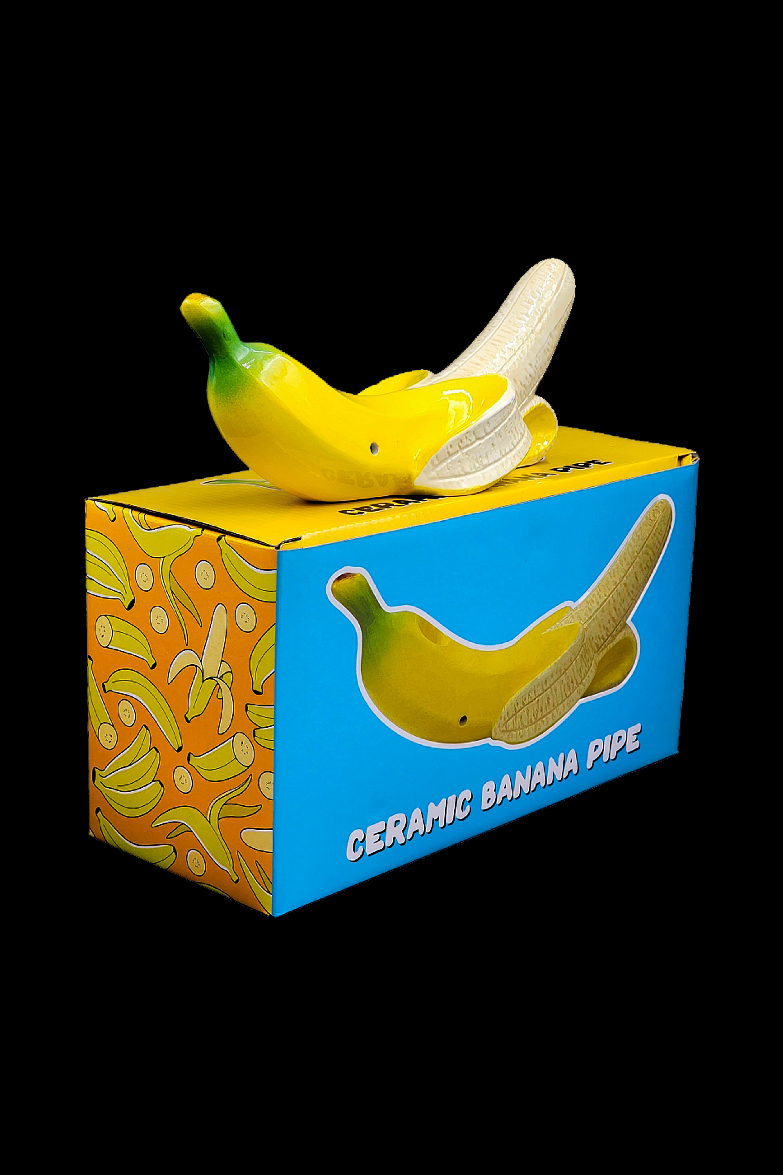 Yellow ceramic banana pipe displayed in its patterned box.